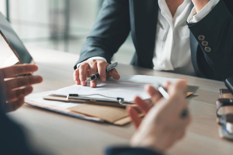  business people looking over documents